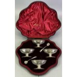 SET OF FOUR EDWARD VII PIERCED PEDESTAL SALTS & TWO SPOONS - in original fitted case, Sheffield