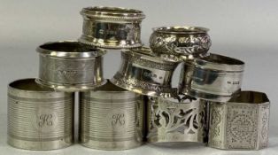 NINE BIRMINGHAM SILVER NAPKIN RINGS - pierced, engraved, embossed and other decorations to include a