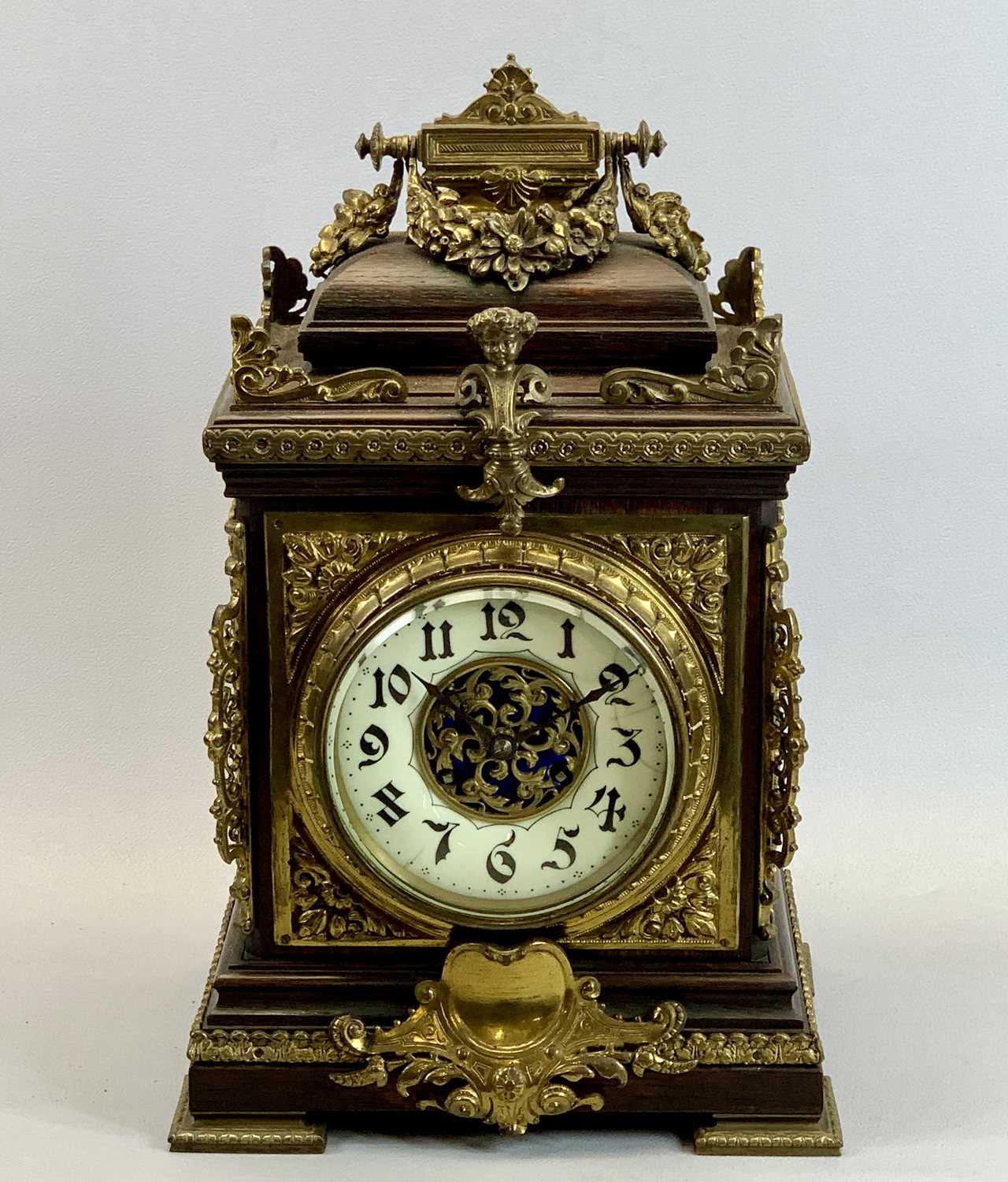 A FRENCH OAK & GILDED ORMOLU MOUNTED MANTEL CLOCK - late 19th Century, cream ceramic dial with black