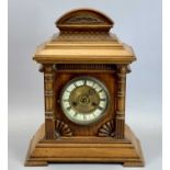 GERMAN WALNUT CASED MANTEL CLOCK - the arched top with carved fish scale decoration, circular dial