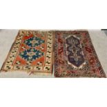 TWO EASTERN STYLE RED GROUND RUGS - one having bordered edging with traditional central pattern
