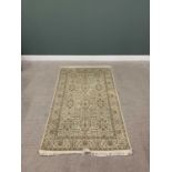 G H FRITH ORIENTAL RECTANGULAR WOOL RUG - central cream and beige repeating floral design with
