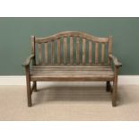 TEAK SLATTED GARDEN BENCH - having a shaped back and arms, 95cms H, 129cms W, 51cms D