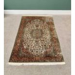 G H FRITH ORIENTAL RECTANGULAR WOOL RUG - central cream and red floral design with patterned borders