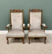 VINTAGE ARTS & CRAFTS STYLE OAK & UPHOLSTERED ARMCHAIRS - a pair, having stylized carved leaf detail