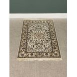 G H FRITH ORIENTAL RECTANGULAR WOOL RUG - cream ground with central floral design, patterned borders