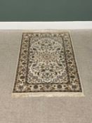 G H FRITH ORIENTAL RECTANGULAR WOOL RUG - cream ground with central floral design, patterned borders