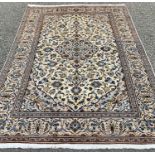 FINE KASHAN RUG, tonal cream and blue ground with extensive floral patterning and motifs to the