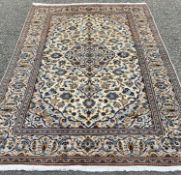 FINE KASHAN RUG, tonal cream and blue ground with extensive floral patterning and motifs to the