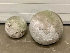TWO STONE GARDEN SPHERES, 35cms and 23cms diam.