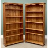 REPRODUCTION PINE OPEN BOOKSHELVES, A PAIR, having three adjustable and two fixed shelves on