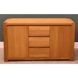 ULTRAMODERN LIGHT OAK SIDEBOARD, having three central opening drawers flanked by twin cupboard doors