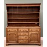 CIRCA 1830 OAK WELSH DRESSER, the three-shelf rack with wide backboards and shaped front detail over
