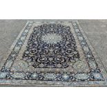 FINE KASHAN RUG, blue ground with stunning central panel of traditional motifs and decorative