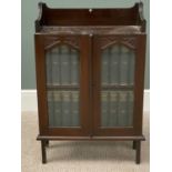 VINTAGE STAINED OAK STANDING BOOKCASE & CONTENTS, having a three quarter railback top over twin