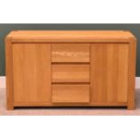 ULTRAMODERN LIGHT OAK SIDEBOARD, having three central opening drawers flanked by twin cupboard doors