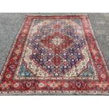 TABRIZ RUG, blue and red ground with traditional central diamond motif and wide border, 290 x