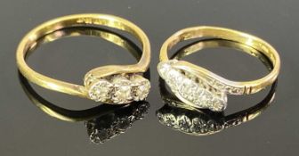 18CT GOLD & PLATINUM DIAMOND RINGS - both being crossover design, the smaller having five inline