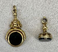 19TH CENTURY UNMARKED GOLD COLOUR WATCH FOB SEALS (2) - the larger with swivel double sided seal