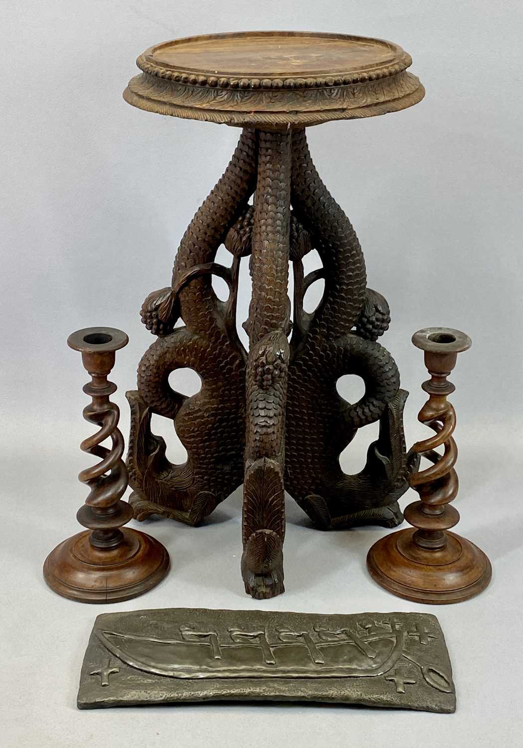 EASTERN HARDWOOD CARVED FISH TRIPOD TABLE, 52cms tall, a pair of open twist treen candlesticks,
