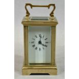SMALL GILT BRASS CASED CARRIAGE CLOCK - with four glass panels, white enamel dial with black Roman