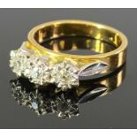 18CT GOLD 3 STONE DIAMOND RING - the diamonds illusion set to individual white metal coronets with