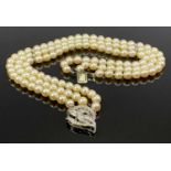 THREE STRAND BELIEVED CULTURED PEARL CHOKER WITH DIAMOND CLASP and diamond set mid row spacers,
