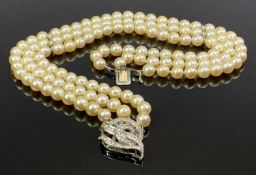 THREE STRAND BELIEVED CULTURED PEARL CHOKER WITH DIAMOND CLASP and diamond set mid row spacers,