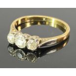 18CT GOLD & PLATINUM 3 STONE DIAMOND RING - the stones in closed edge claw mounts, 0.29cts estimated