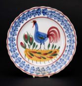 LLANELLY POTTERY COCKEREL PLATE circa 1900, continuous sponged floral border in blue, the interior