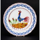 LLANELLY POTTERY COCKEREL PLATE circa 1900, continuous sponged floral border in blue, the interior