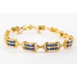 18K GOLD SAPPHIRE & DIAMOND BRACELET, having four double row panels of ten sapphires each accented