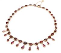 19TH CENTURY GARNET FRINGE NECKLACE, the foil backed stones set in closed back settings with pinched