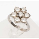 18CT WHITE GOLD DIAMOND CLUSTER RING, set with seven brilliant cut diamonds in a flower shape, shank