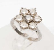 18CT WHITE GOLD DIAMOND CLUSTER RING, set with seven brilliant cut diamonds in a flower shape, shank