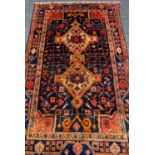 NAVAHAN TRIBAL RUG, double lozenge medallion on a blue abrash field, stylised vine border, 260 x