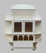 SMALL VICTORIAN HANGING CABINET with spindled galleries, quarter circle shelves and later mirrored