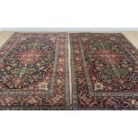 PAIR ISFAHAN RUGS, each with red floral medallion between green oval panels, on a dark scrolling