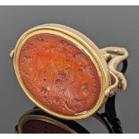 19TH CENTURY YELLOW METAL ARMORIAL REVOLVING SEAL FOB, the intaglio carnelian carved with the arms