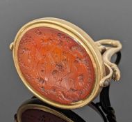 19TH CENTURY YELLOW METAL ARMORIAL REVOLVING SEAL FOB, the intaglio carnelian carved with the arms