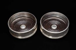 PAIR SILVER BOTTLE COASTERS, Richard Comyns, London 1992, with turned wood bases, initial and date
