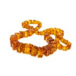 FACETED BALTIC AMBER NECKLACE, comprising 60 graduated square-cut beads with natural inclusions,