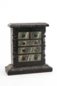 NORTH WALES FOLK ART SLATE MODEL CHEST OF DRAWERS, with decorated drawer fronts and shaped angles,