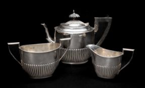 EDWARD VII SILVER BACHELOR'S TEA SET, Walker & Hall, Sheffield 1902-4, oval half fluted form,