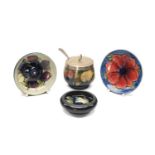 FOUR ITEMS MOORCROFT POTTERY, comprising 'Wisteria' pattern preserve jar and plated cover, '