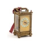 19TH CENTURY GILT BRASS CARRIAGE CLOCK, fancy case with Arabic enamel chapter ring, swing handle.