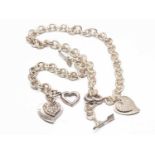 WHITE METAL OPEN HEART & ARROW NECKLACE together with matching bracelet, both with heart drops