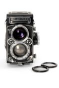 A ROLLEI F&H ROLLEIFLEX 2.8F MEDIUM FORMAT CAMERA - black, serial no. E32360922, with a Carl