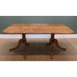 GEORGE III STYLE TWIN PEDESTAL EXTENDING DINING TABLE, the moulded top above leaf carved splayed