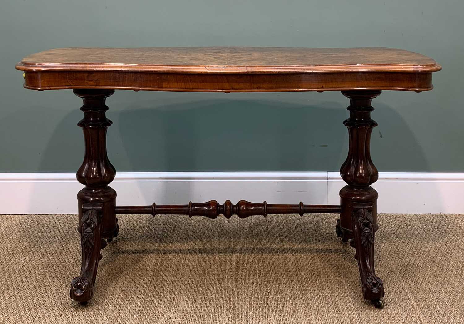 MID-VICTORIAN FIGURED WALNUT TRESTLE TABLE, shaped moulded top on lobed baluster supports and